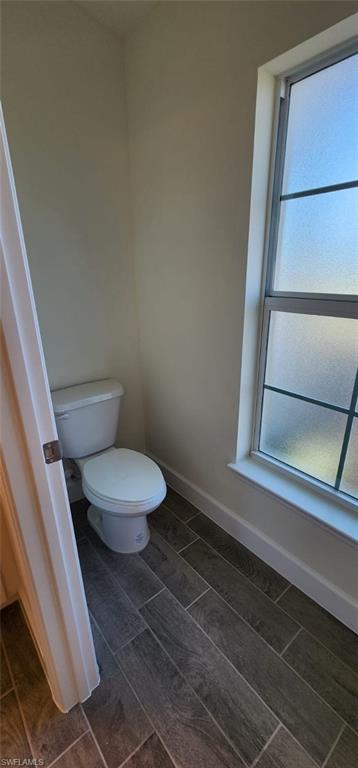 Bathroom featuring baseboards and toilet
