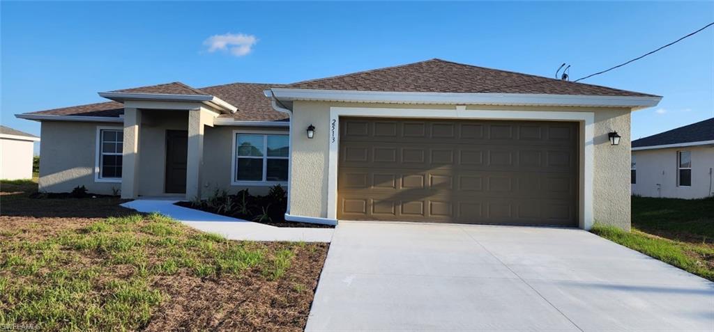 Single story home featuring stucco siding, roof with shingles, concrete driveway, and a garage
