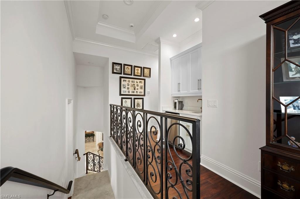 Landing to third floor with breakfast bar area, sink and refrigerator