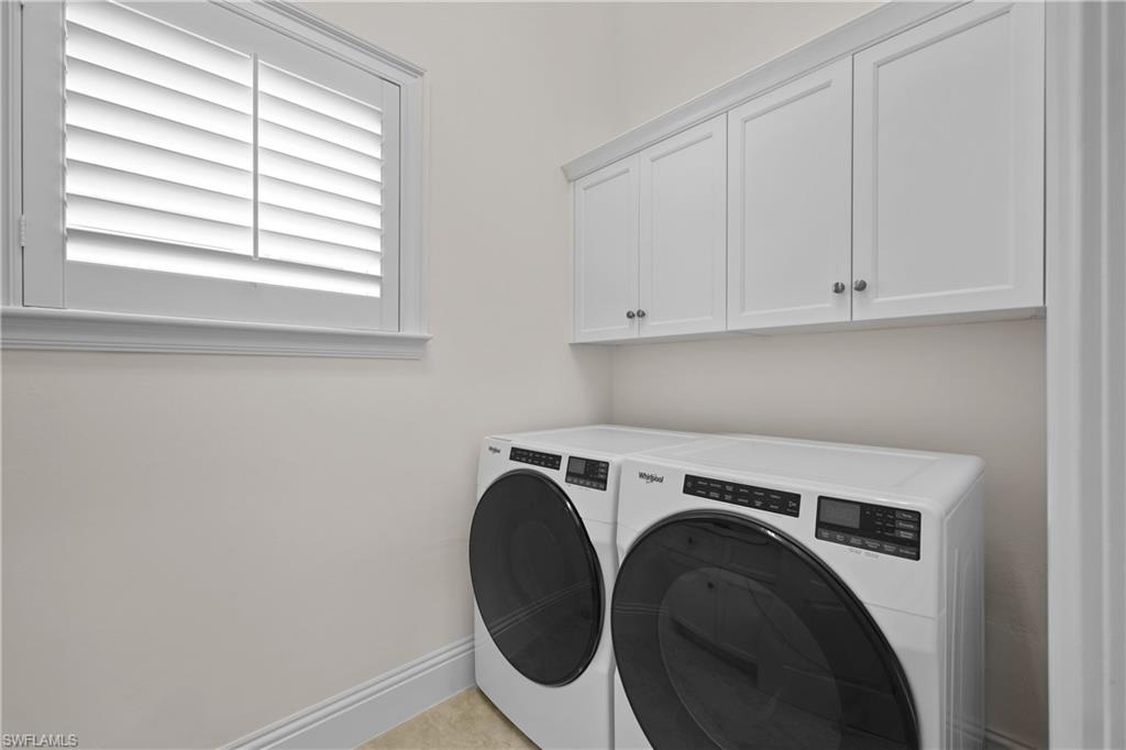 Laundry room, recent washer and dryer and sink with Quartz top