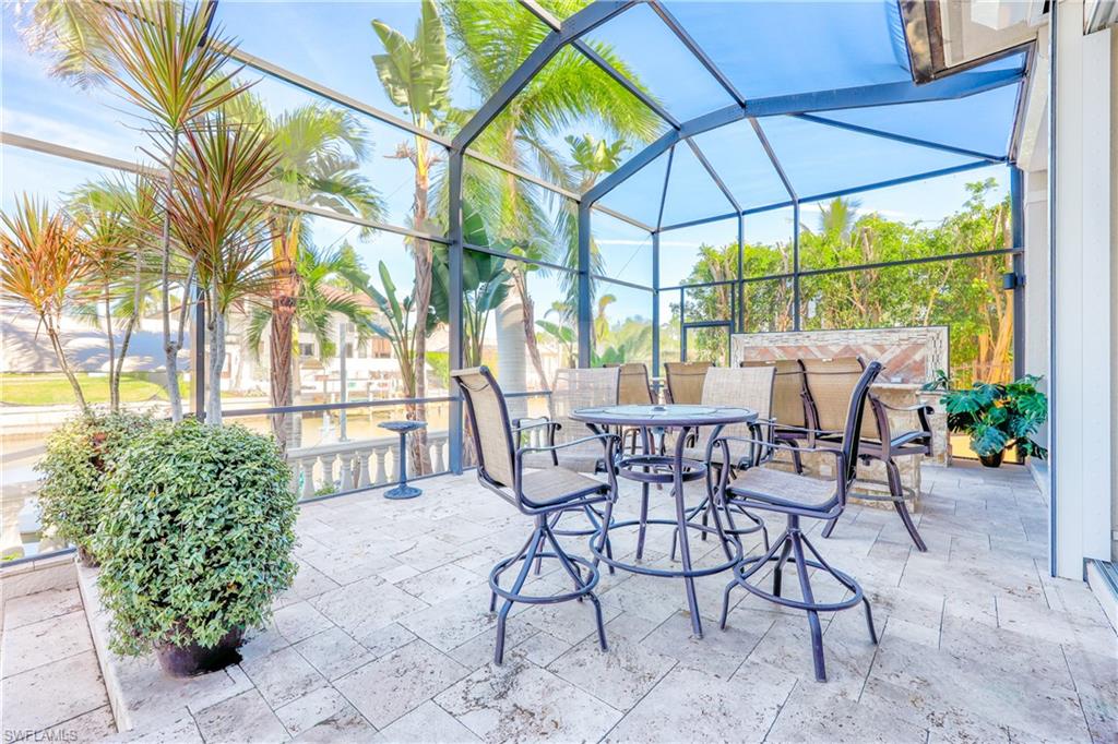 Lanai extends to dining and barbecue area with grill and counter
