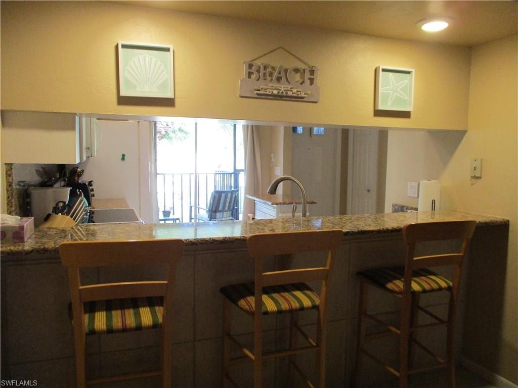 Kitchen Eat-In Bar With Pass-Through to Living Room with bar stools