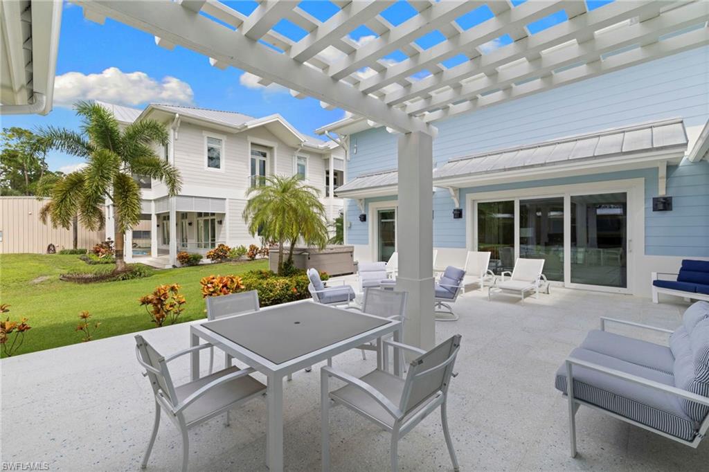 View of patio with a pergola, outdoor dining area, and a hot tub
