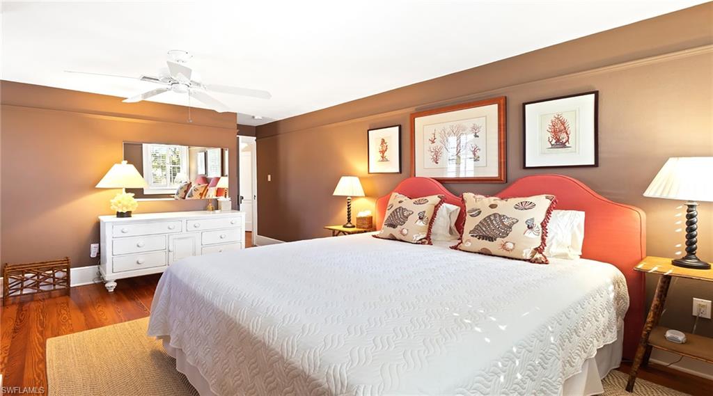 Bedroom with dark wood finished floors and a ceiling fan