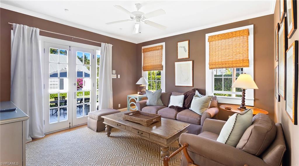 Living area featuring a ceiling fan, wood finished floors, french doors, and ornamental molding
