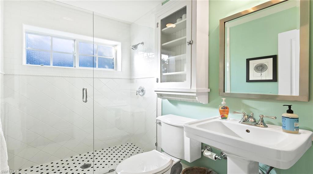 Bathroom with a stall shower and toilet