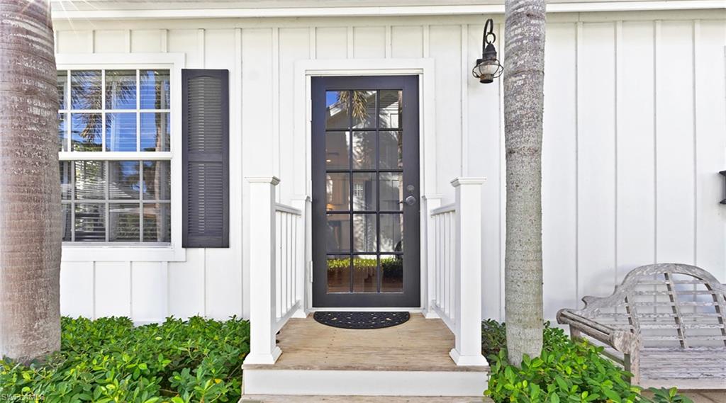 Doorway to property featuring board and batten siding