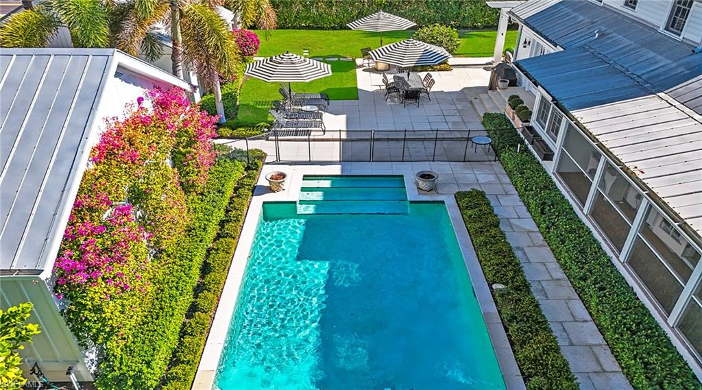 View of pool with patio surround and outdoor dining area