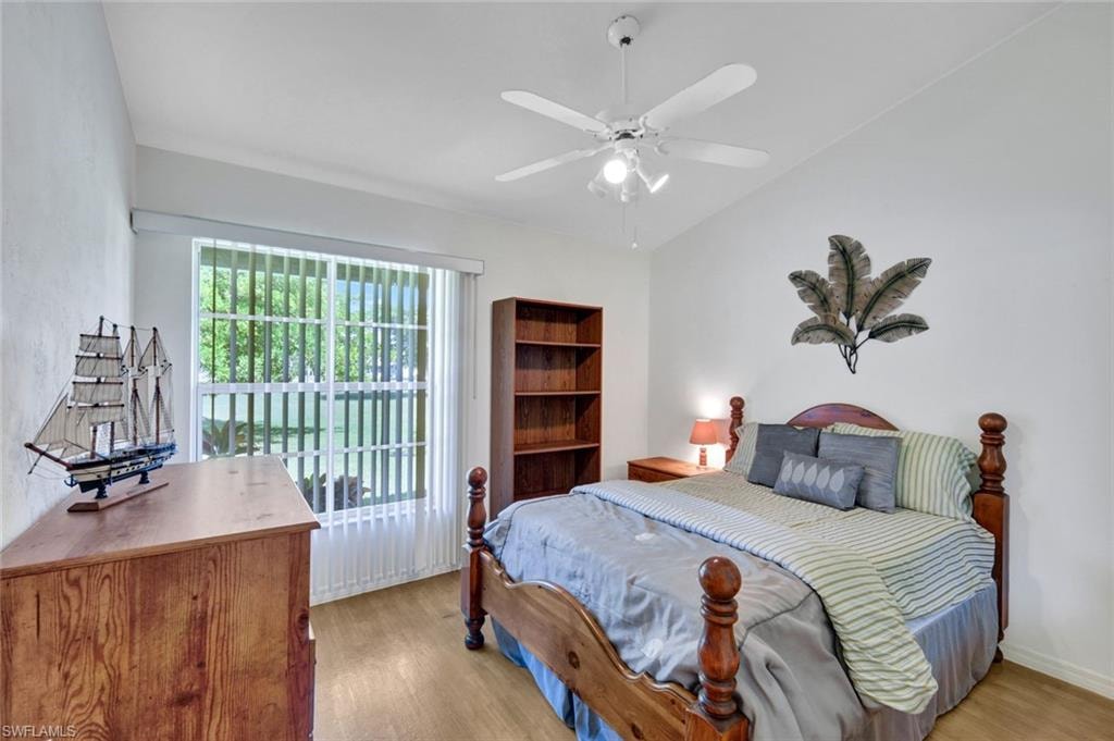 Guest bedroom featuring light wood-style flooring and a ceiling fan