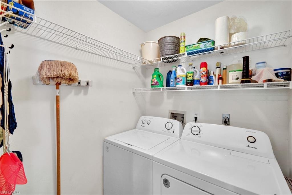 Laundry room with washer and dryer and storage