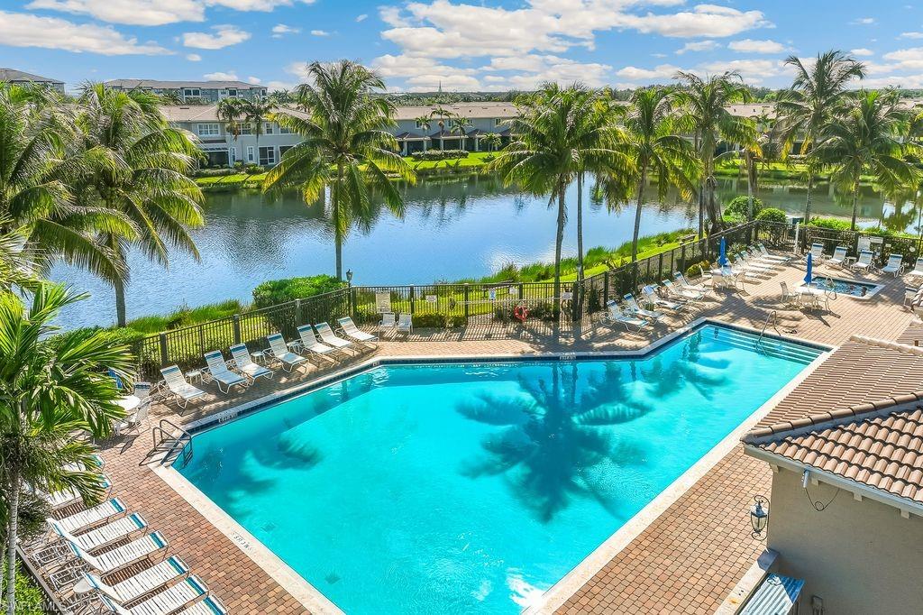 Aerial view of the Community Pool featuring a patio and a water view