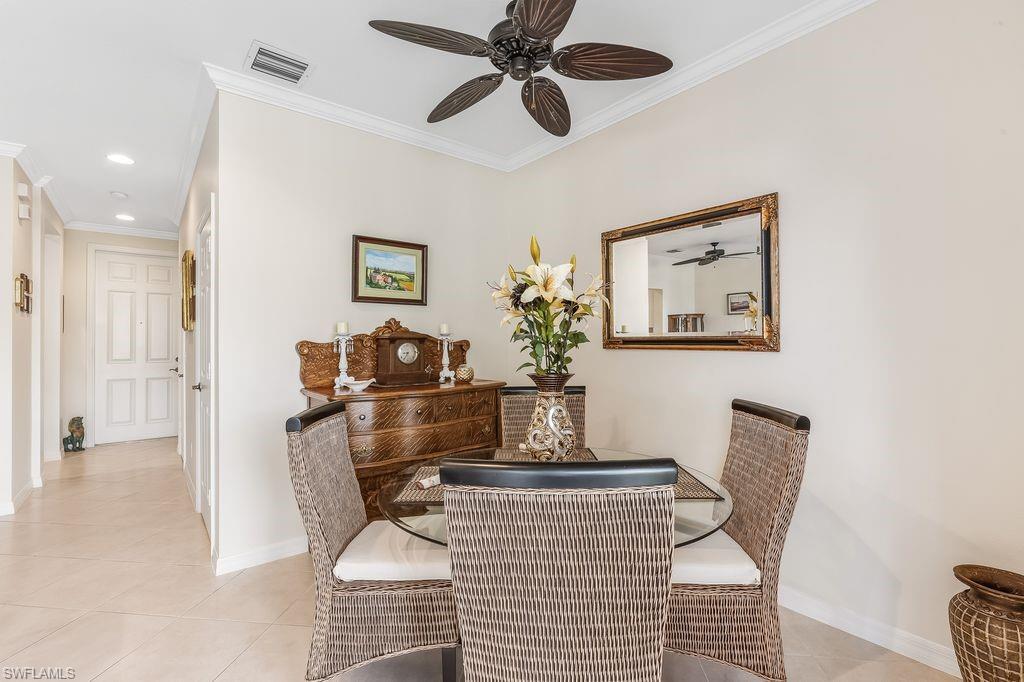 Dining area with light tile patterned floors, ornamental molding, a ceiling fan, and recessed lighting
