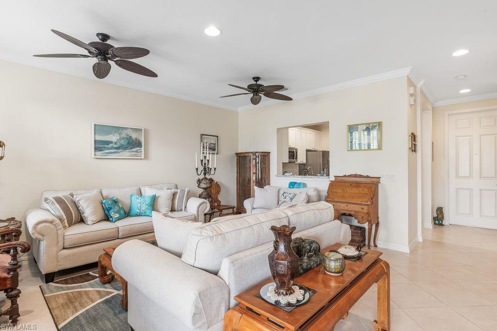 Tiled living room featuring crown molding, recessed lighting, and a ceiling fan