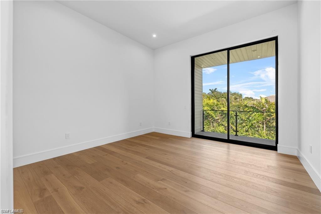 Unfurnished room with light wood-type flooring and recessed lighting