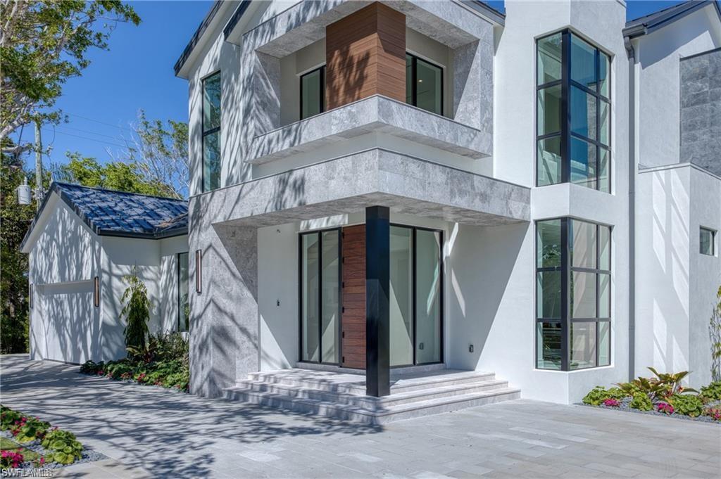 Property entrance with stucco siding and a garage