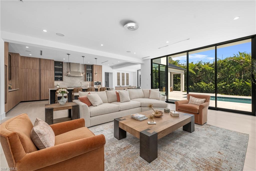 Living room with a wall of windows and recessed lighting