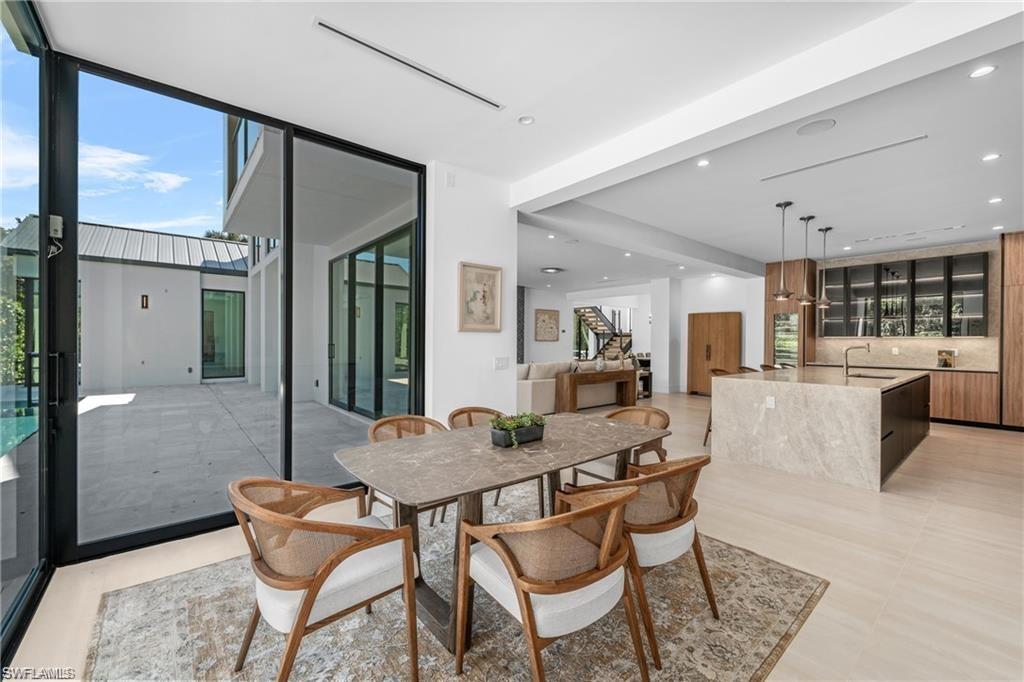 Dining space with floor to ceiling windows and recessed lighting