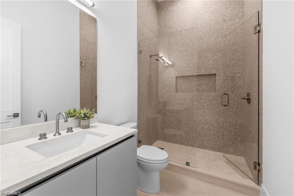 Full bath with a stall shower and vanity