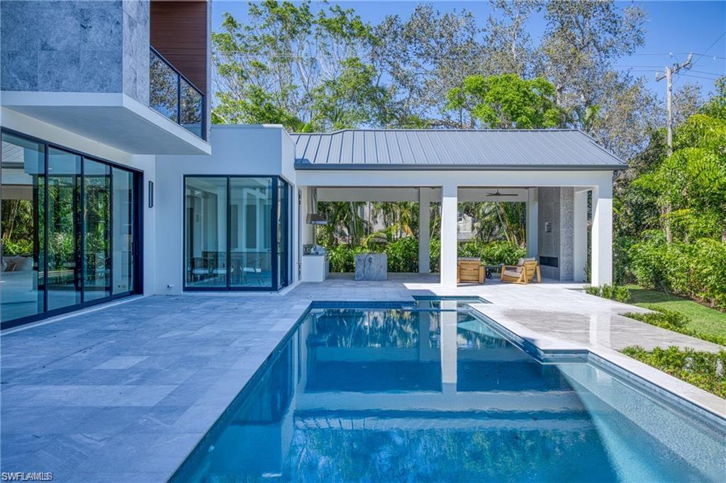 Outdoor pool with a patio area and a balcony