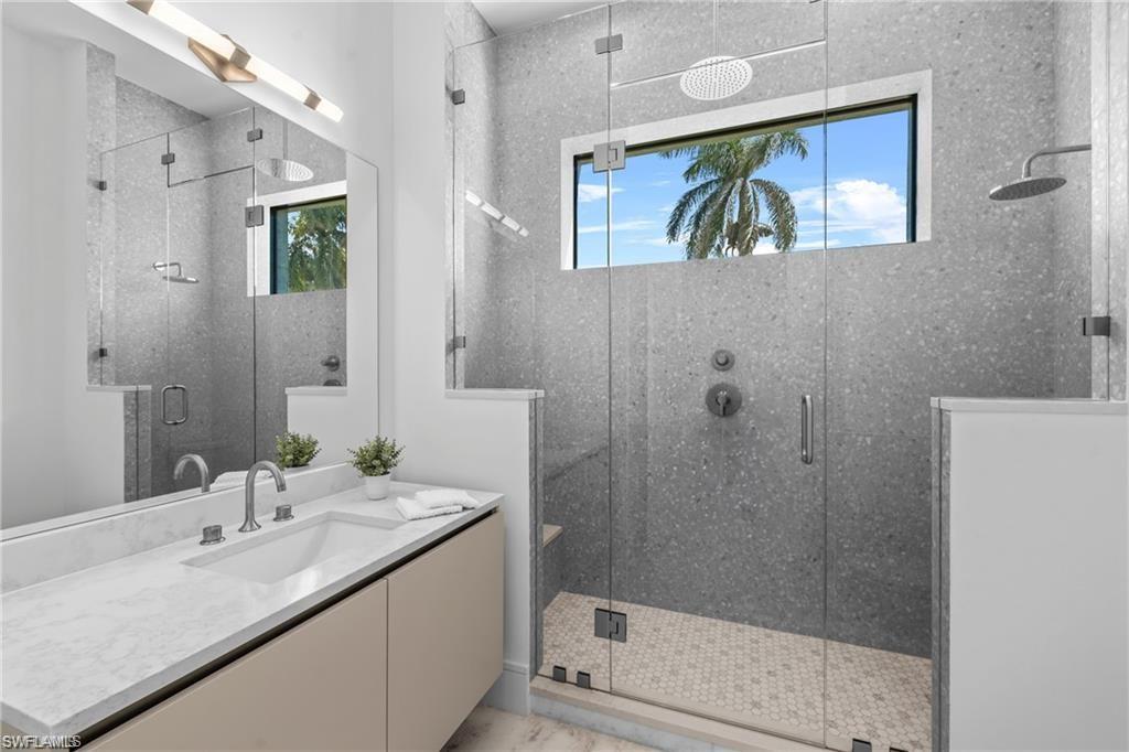 Bathroom featuring vanity and a stall shower