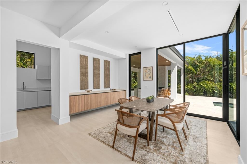 Dining room with healthy amount of natural light and floor to ceiling windows