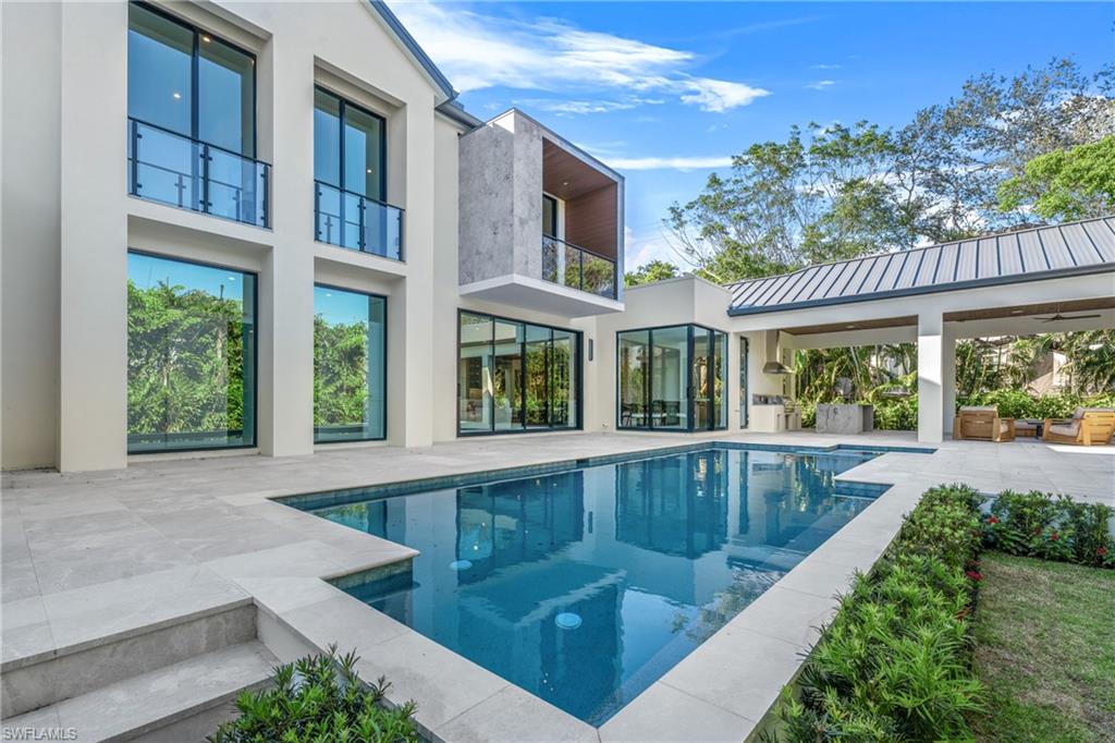 Swimming pool with a patio and a balcony