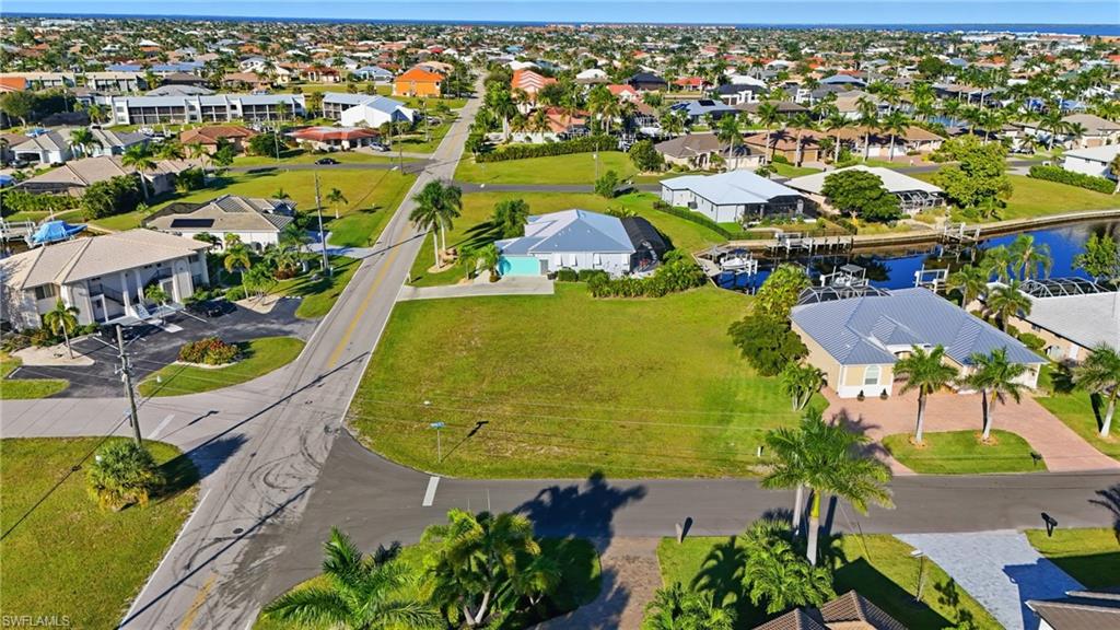 Aerial perspective of suburban area featuring a large body of water