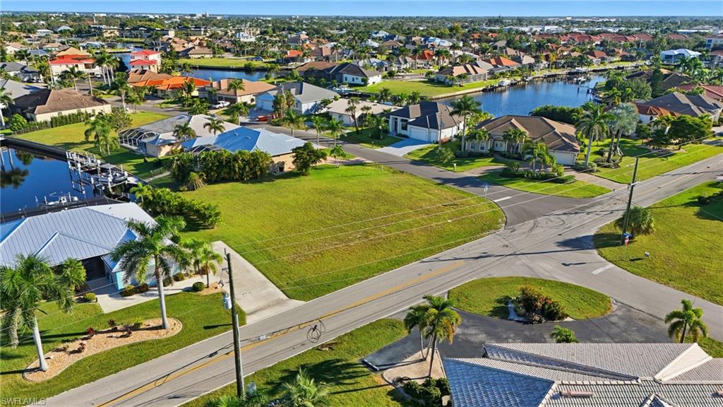 Aerial view of residential area featuring a nearby body of water