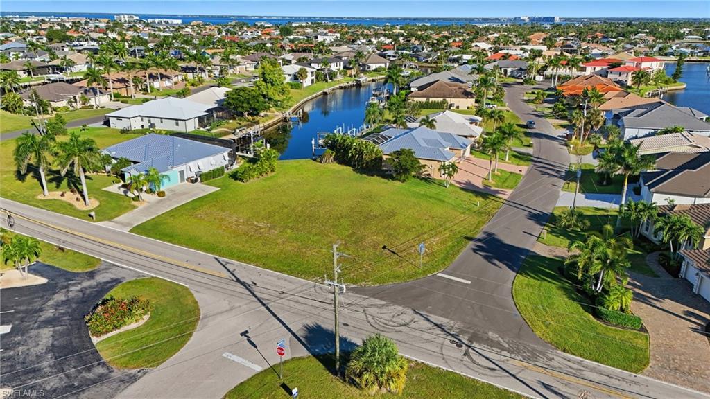 Aerial view of residential area featuring a nearby body of water
