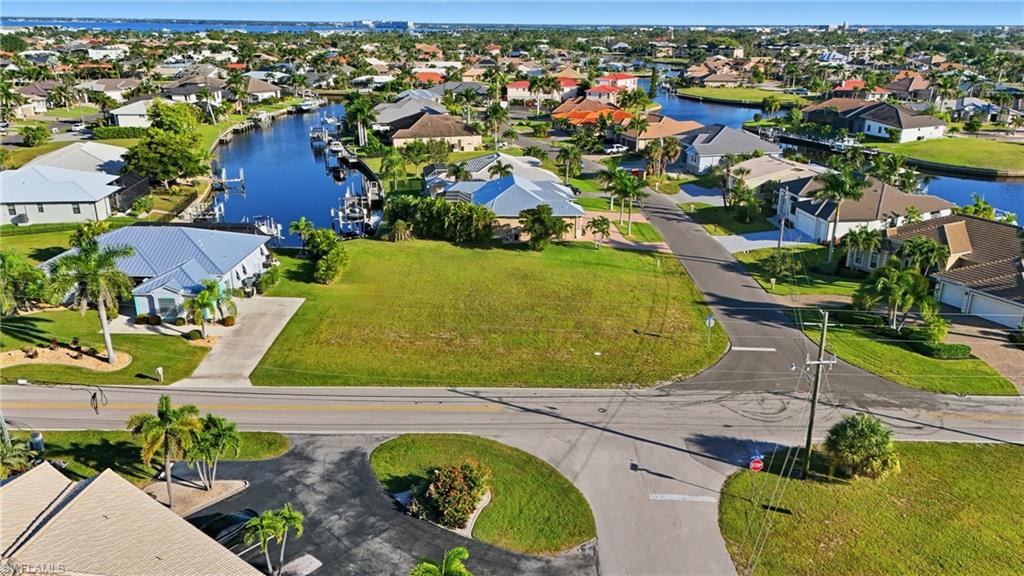 Aerial perspective of suburban area featuring a large body of water