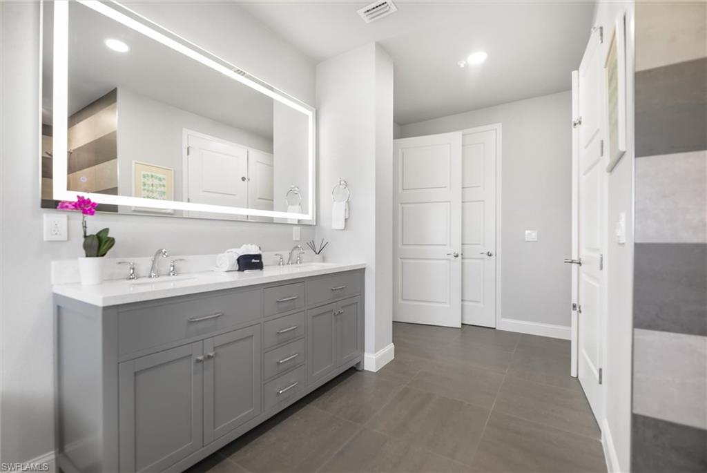 Bathroom with double vanity and recessed lighting