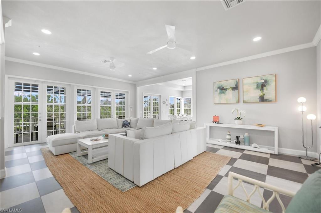 Living area featuring ornamental molding, light floors, recessed lighting, and a ceiling fan