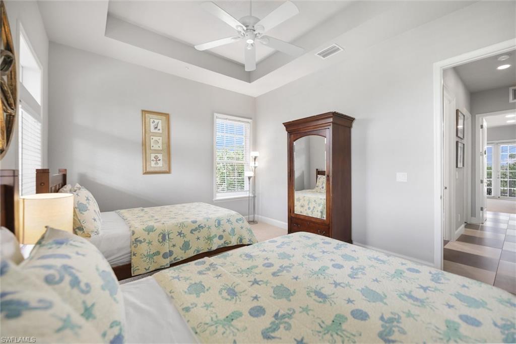 Bedroom featuring a tray ceiling and a ceiling fan