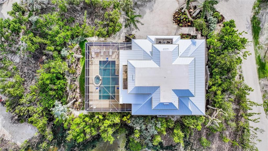 Aerial view of property and surrounding area with a pool area