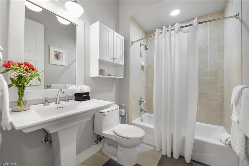 Bathroom with shower / bath combo with shower curtain and toilet
