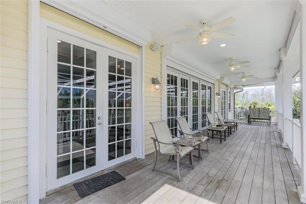 Wooden deck featuring french doors and a ceiling fan