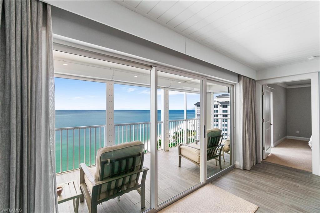 Doorway with a water view and wood finished floors