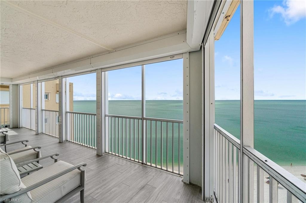 Unfurnished sunroom with a water view and healthy amount of natural light