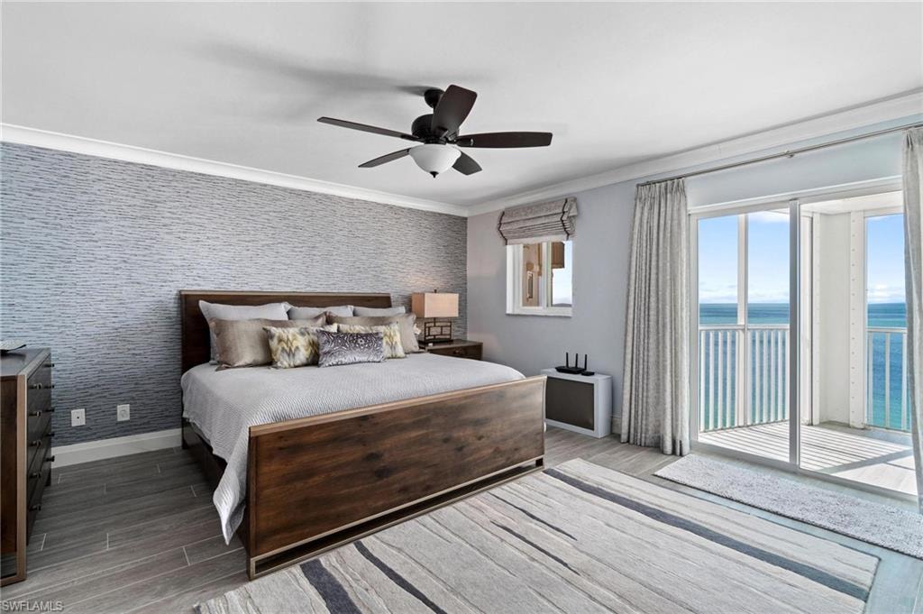 Bedroom featuring ornamental molding, access to exterior, wood finished floors, ceiling fan, and wallpapered walls