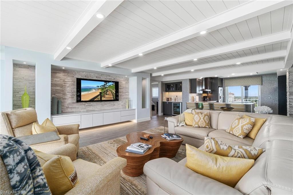 Living area with beam ceiling, wood finished floors, recessed lighting, and wine cooler