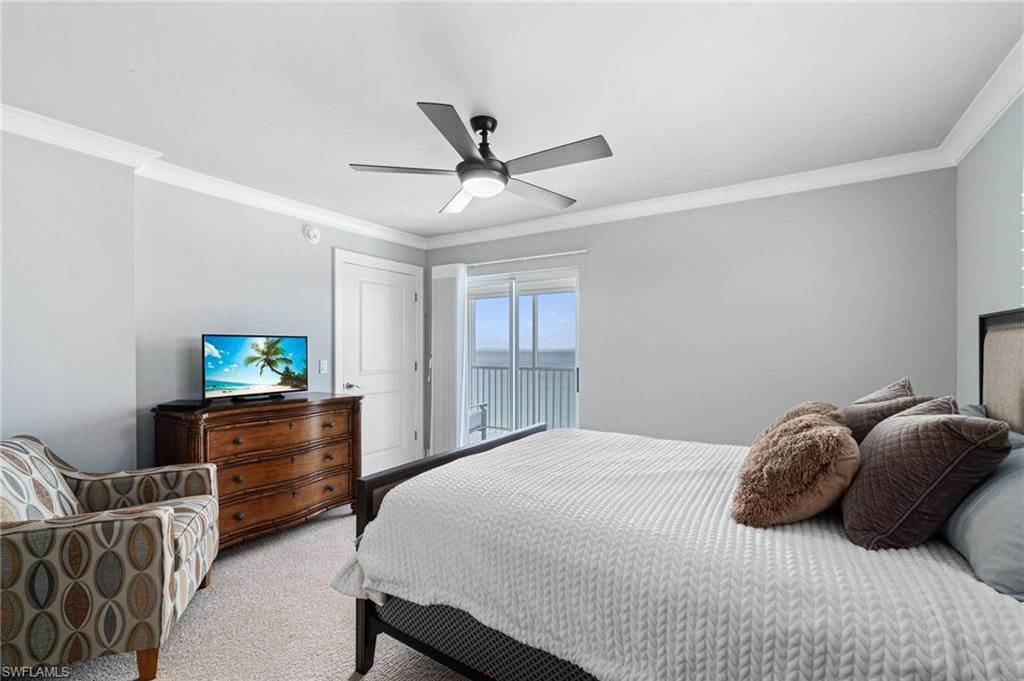 Bedroom featuring ornamental molding, access to outside, carpet, and a ceiling fan