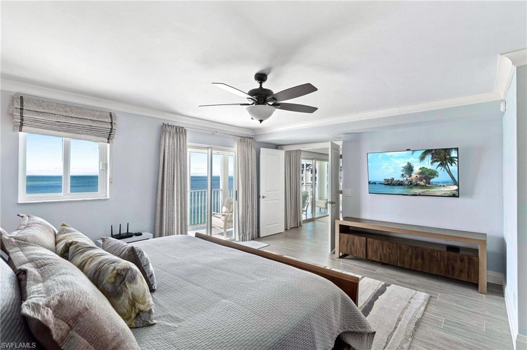Bedroom with wood finished floors, crown molding, access to outside, and ceiling fan
