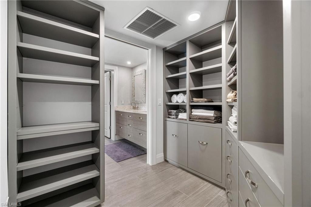 Spacious closet with light wood-style flooring