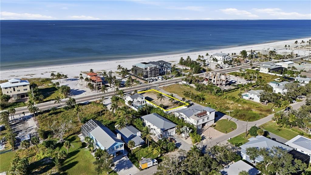 Aerial overview of property's location featuring expansive beach - Virtually Edited Image