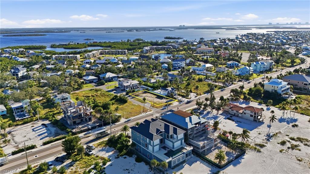 Aerial perspective of suburban area with a nearby body of water - Virtually Edited Image