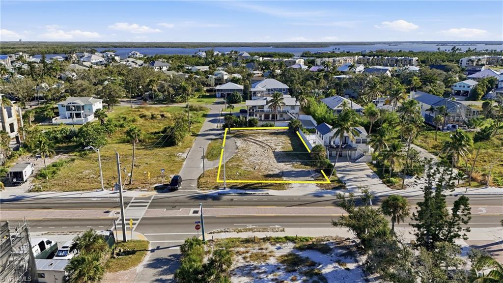 Aerial perspective of suburban area featuring property parcel outlined - Virtually Edited Image