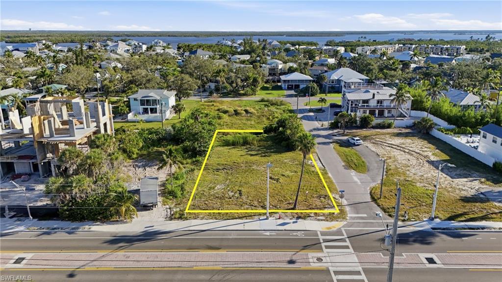 Aerial view of residential area featuring property parcel outlined - Virtually Edited Image