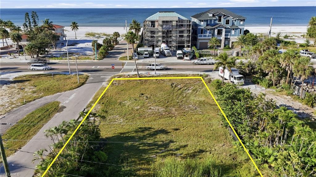 Aerial view of property's location with property boundaries highlighted and extended coastline - Virtually Edited Image