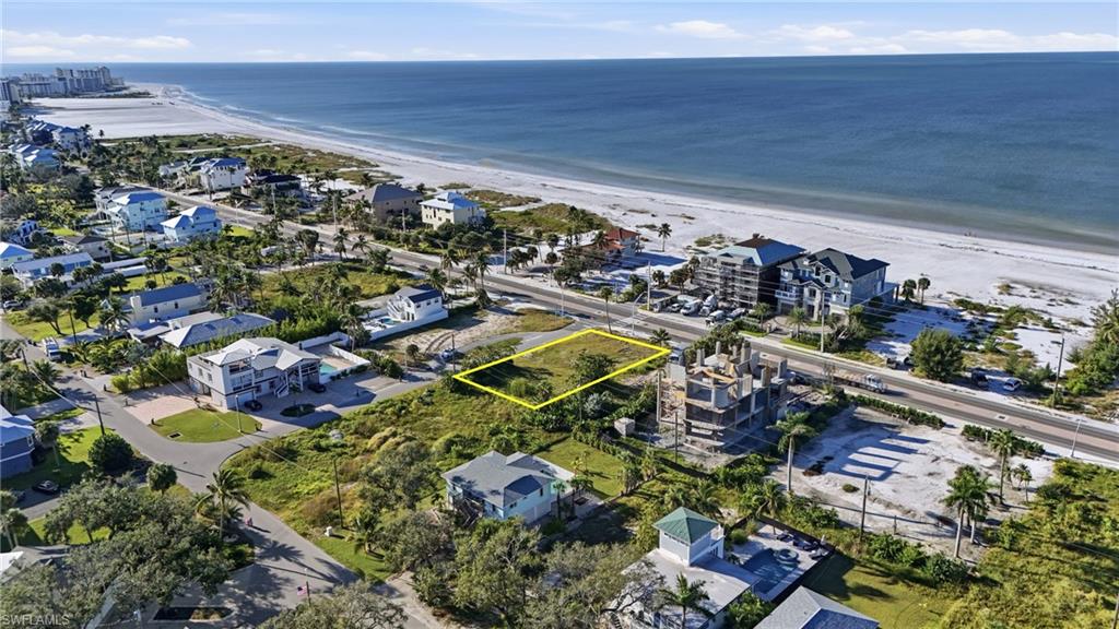 Aerial perspective of suburban area with property boundaries highlighted and expansive coastline - Virtually Edited Image