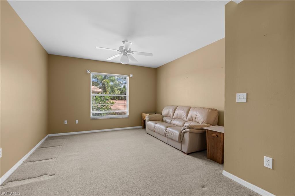 Neutral-toned walls and light-colored carpeting define this spacious room